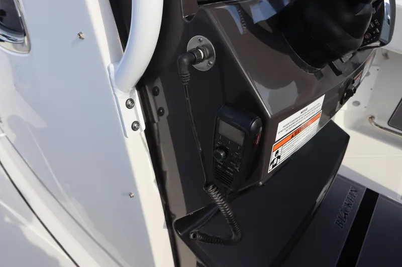 Slide: The Image of 2023 Blackfin 272 CC boat console with radio and safety instructions. - 29