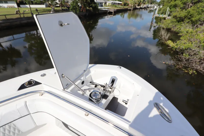 Slide: The Image of 2023 Blackfin 272 CC boat with open storage compartment on a calm waterway. - 34