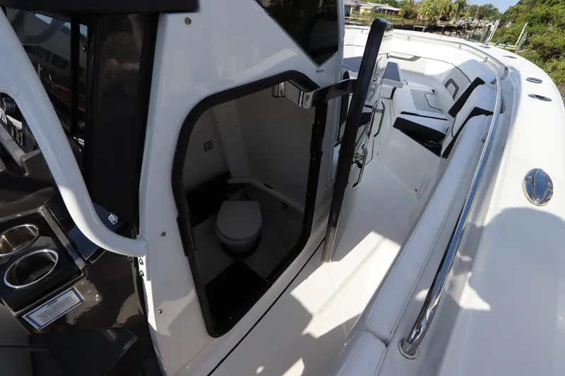 Slide: The Image of 2023 Blackfin 272 CC boat interior with open cabin door and visible toilet. - 37