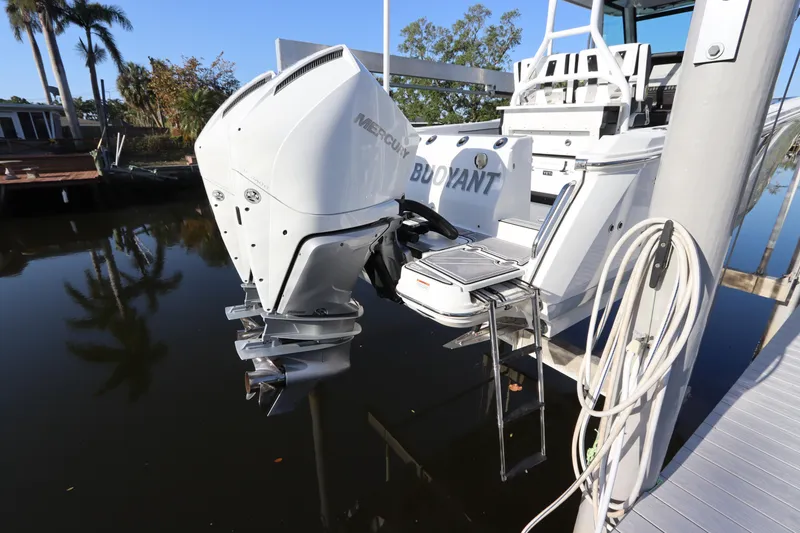 Slide: The Image of 2023 Blackfin 272 CC boat with Mercury outboard motor docked by water. - 4