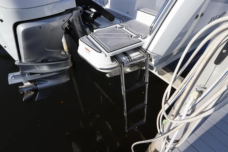 Slide: The Image of 2023 Blackfin 272 CC boat with ladder and outboard motor in water. - 5