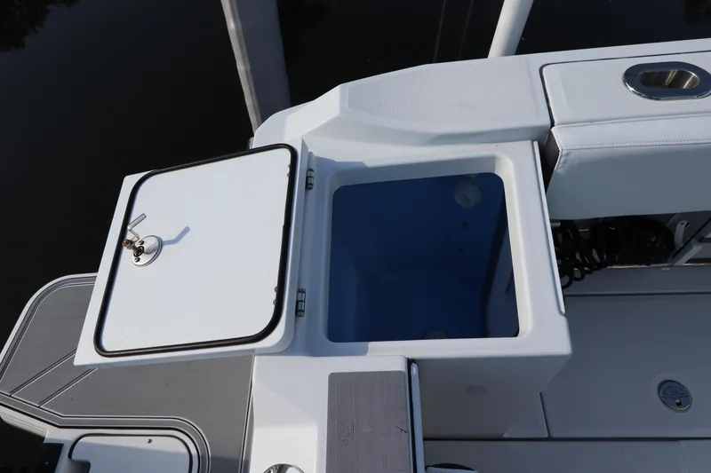 Slide: The Image of 2023 Blackfin 272 CC boat with open storage compartment, showcasing sleek design and functionality. - 9
