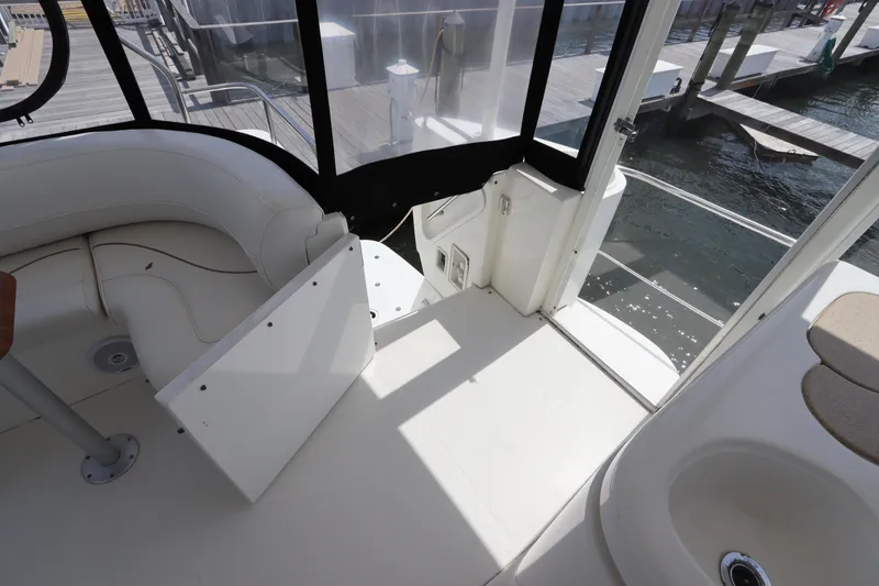 Slide: The Image of 2000 Cruisers Yachts 4450 Express Motoryacht interior with white seating and water view. - 10