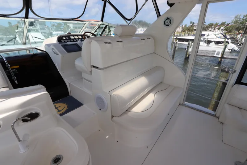 Slide: The Image of 2000 Cruisers Yachts 4450 Express Motoryacht interior with helm and seating area. - 13