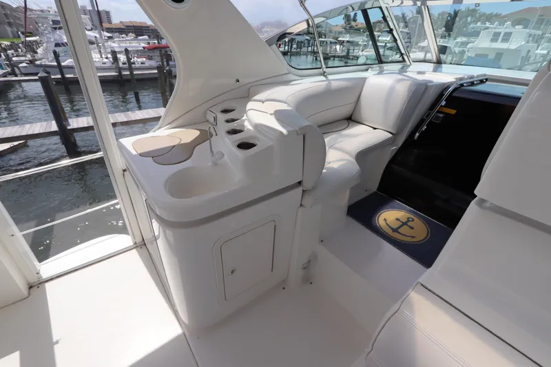Slide: The Image of 2000 Cruisers Yachts 4450 Express Motoryacht interior with seating and dock view. - 17