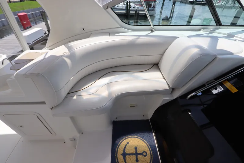 Slide: The Image of Luxurious white seating on 2000 Cruisers Yachts 4450 Express Motoryacht, dockside view. - 18