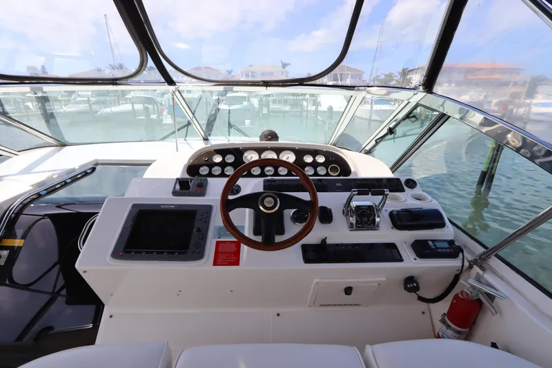 Slide: The Image of Helm of 2000 Cruisers Yachts 4450 Express Motoryacht with steering wheel and control panel. - 21