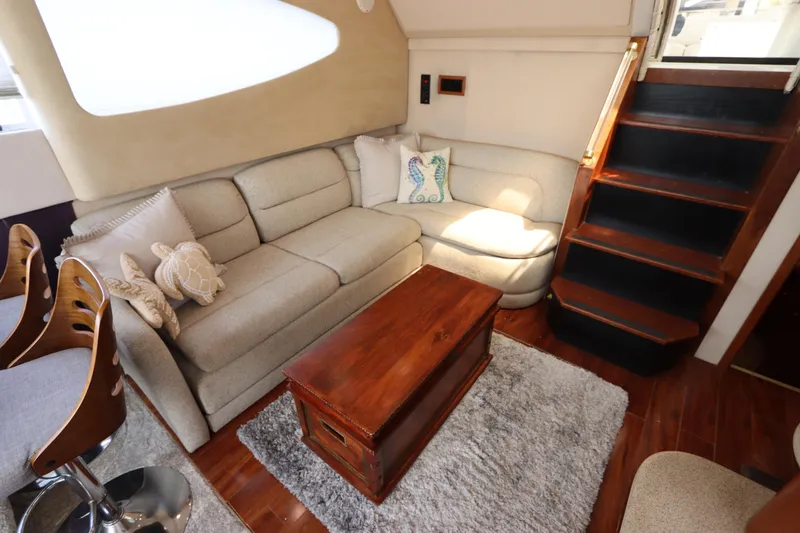 Slide: The Image of Luxurious interior of 2000 Cruisers Yachts 4450 Express Motoryacht with cozy seating and wooden accents. - 27