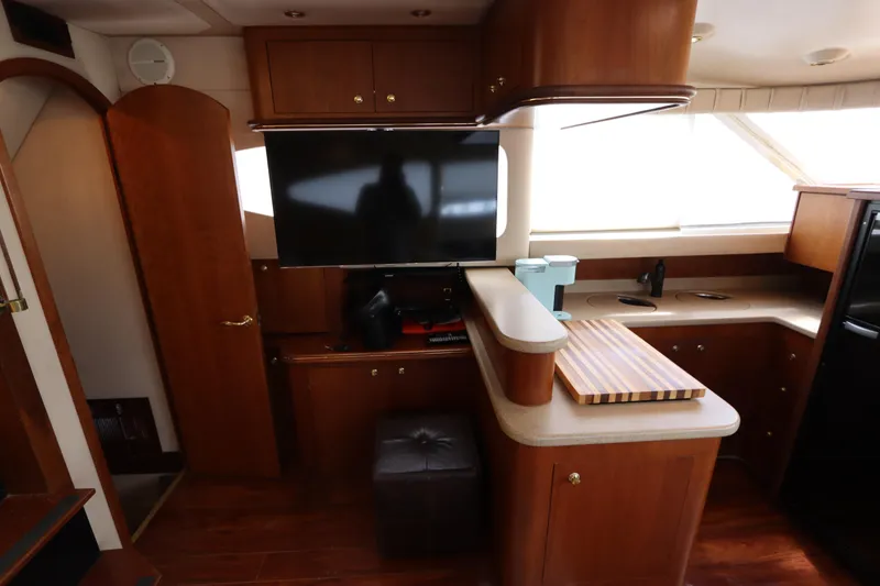 Slide: The Image of Interior of 2000 Cruisers Yachts 4450 Express Motoryacht with wood cabinetry and modern amenities. - 28
