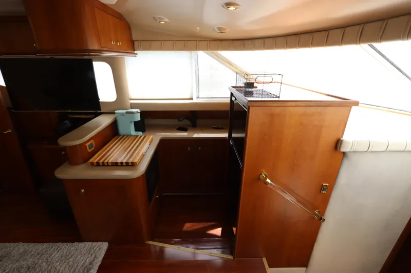 Slide: The Image of Interior of 2000 Cruisers Yachts 4450 Express Motoryacht with wooden cabinetry and modern amenities. - 29