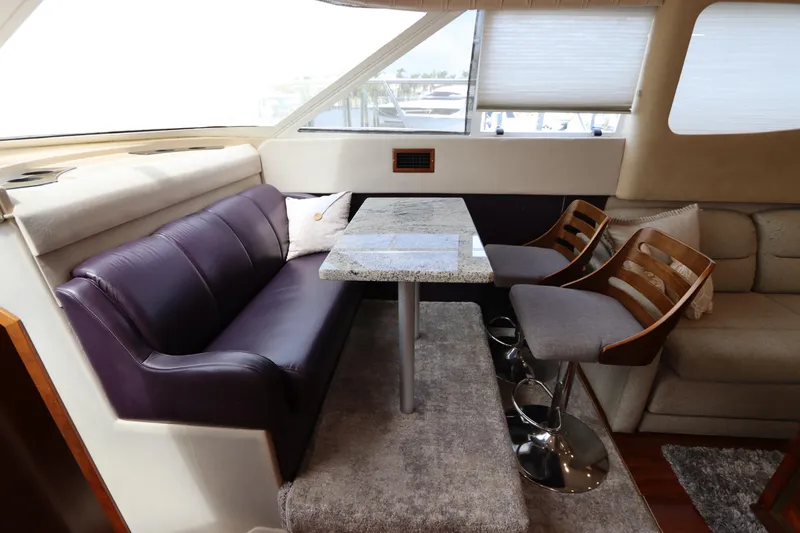 Slide: The Image of Interior of 2000 Cruisers Yachts 4450 Express Motoryacht with plush seating and dining area. - 34