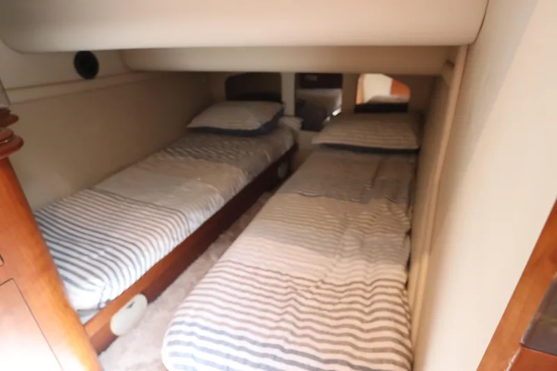 Slide: The Image of Twin beds in 2000 Cruisers Yachts 4450 Express Motoryacht cabin, striped bedding. - 37