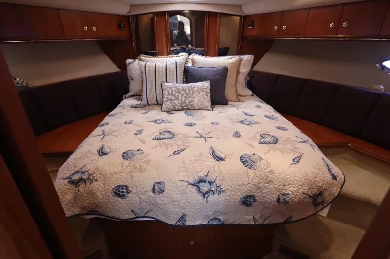 Slide: The Image of Luxurious bedroom in 2000 Cruisers Yachts 4450 Express Motoryacht with nautical-themed bedding. - 42