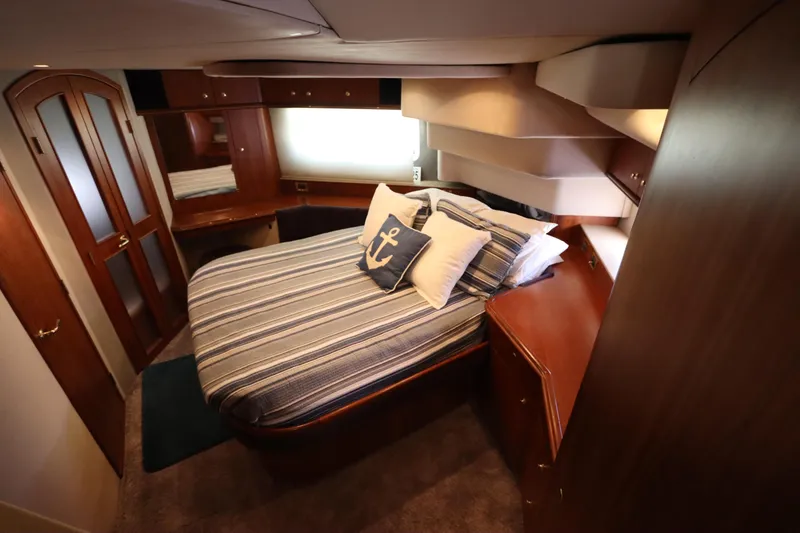 Slide: The Image of Luxurious bedroom in 2000 Cruisers Yachts 4450 Express Motoryacht with nautical decor. - 44