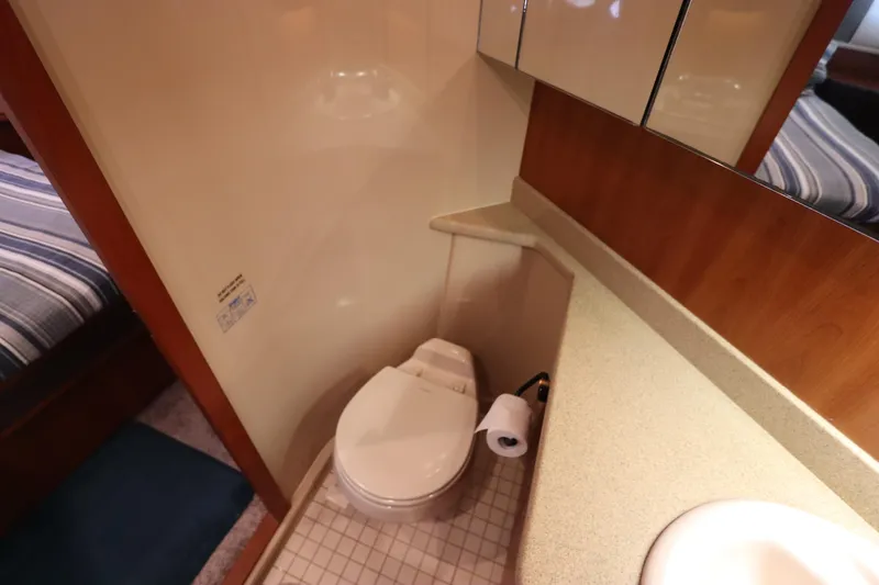 Slide: The Image of Bathroom interior of 2000 Cruisers Yachts 4450 Express Motoryacht, featuring toilet and sink. - 48