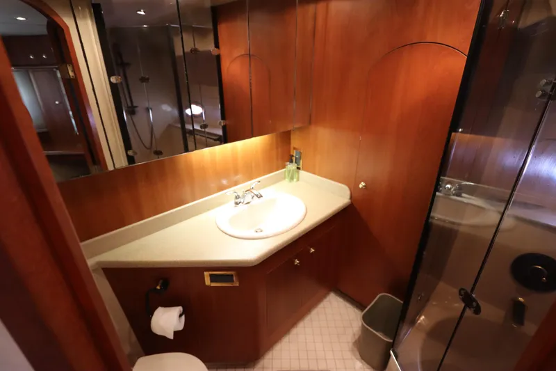 Slide: The Image of Luxurious bathroom in 2000 Cruisers Yachts 4450 Express Motoryacht with wood accents and modern fixtures. - 49