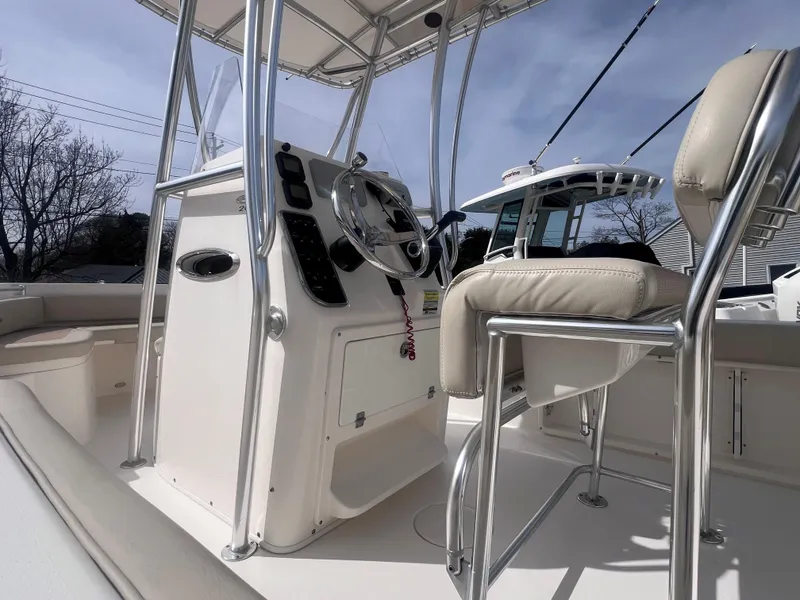 Slide: The Image of 2014 Cobia 201 Center Console boat interior with steering wheel and seating. - 10