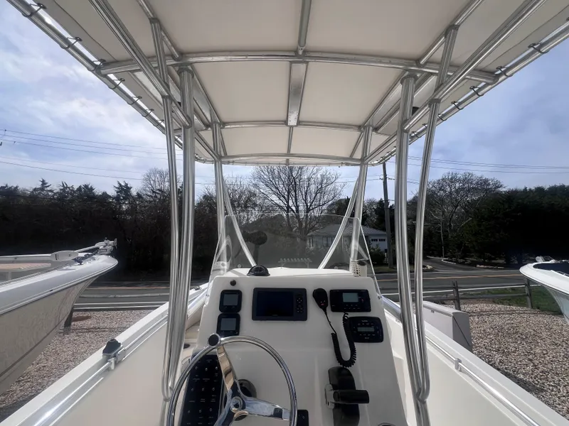 Slide: The Image of 2014 Cobia 201 Center Console boat interior with steering wheel and navigation equipment. - 11