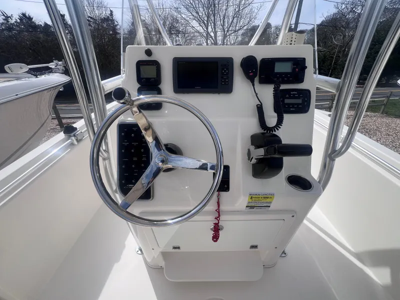 Slide: The Image of 2014 Cobia 201 Center Console boat dashboard with steering wheel and navigation controls. - 12