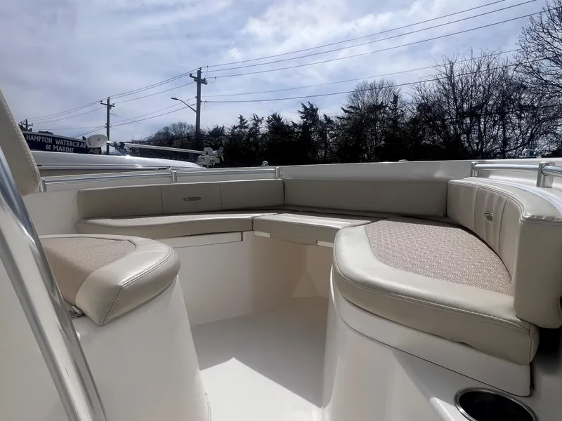 Slide: The Image of 2014 Cobia 201 Center Console boat with spacious seating area under cloudy sky. - 15