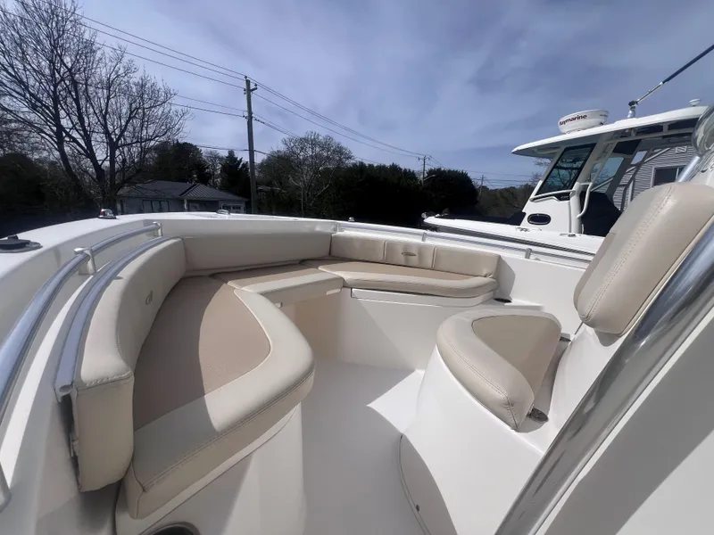 Slide: The Image of 2014 Cobia 201 Center Console boat with beige seating, outdoor view. - 16