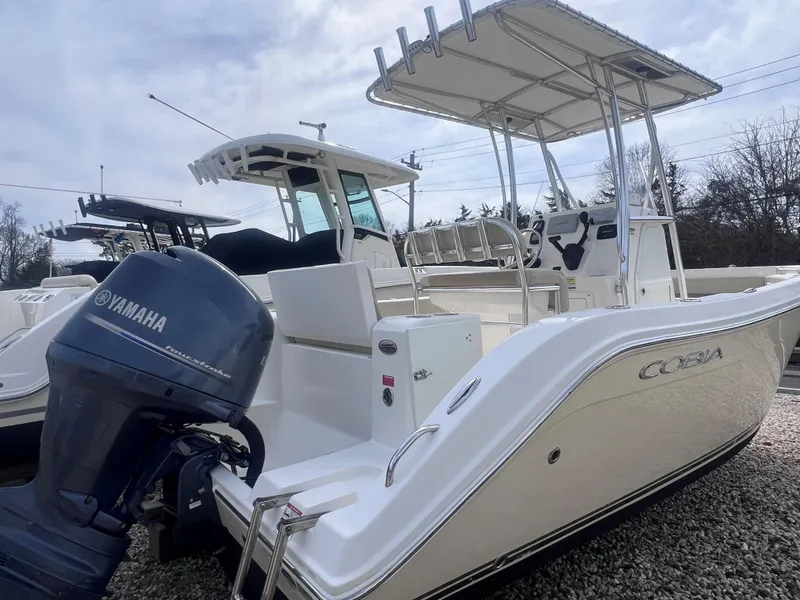 Slide: The Image of 2014 Cobia 201 Center Console boat with Yamaha engine, parked on gravel. - 5