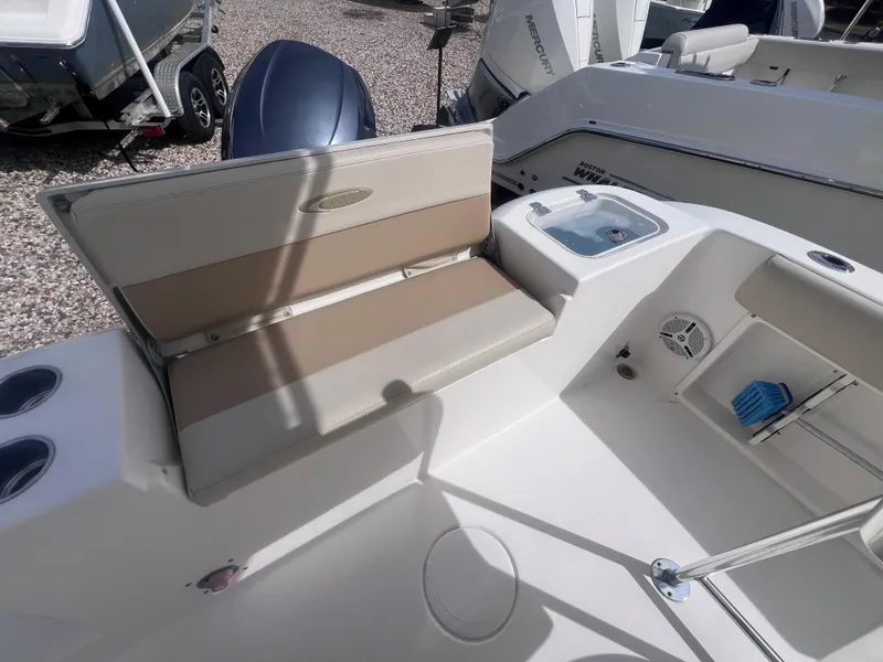 Slide: The Image of 2014 Cobia 201 Center Console boat interior with seating and storage compartments. - 8