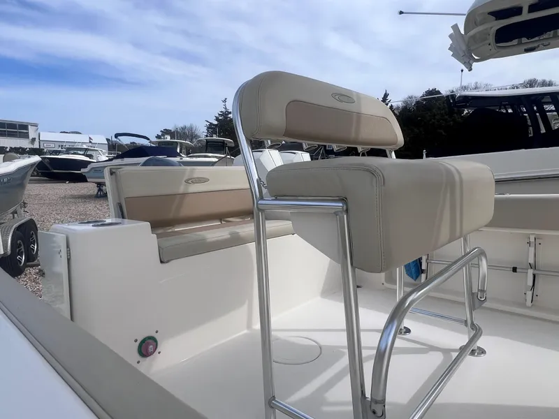 Slide: The Image of 2014 Cobia 201 Center Console boat with beige seating and stainless steel frame. - 9