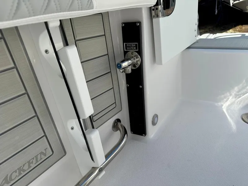 Slide: The Image of 2024 Blackfin 222CC boat interior with fresh water access and sleek design elements. - 10