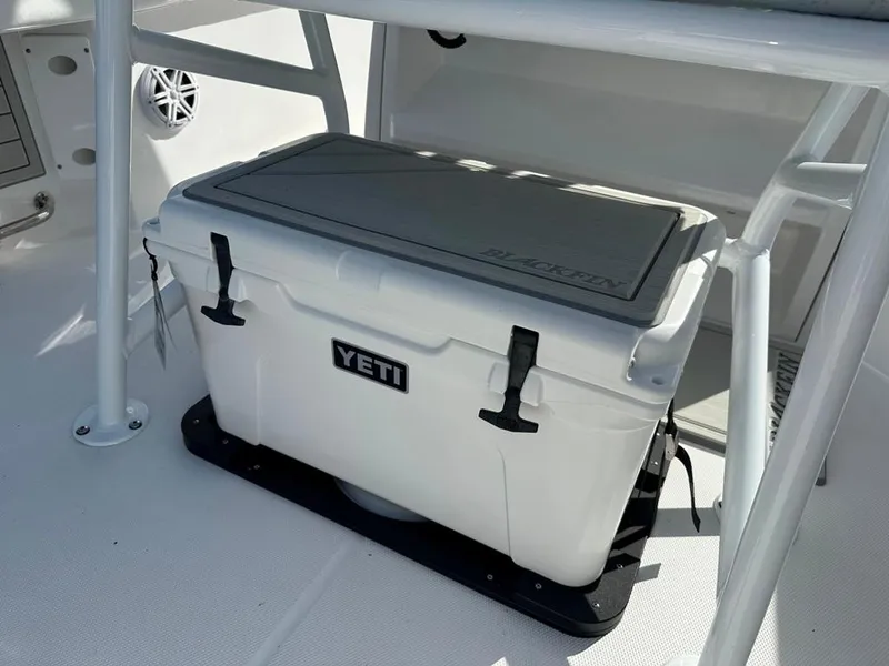 Slide: The Image of 2024 Blackfin 222CC boat with Yeti cooler secured on deck. - 16