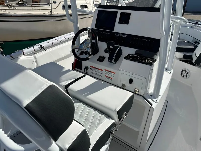 Slide: The Image of 2024 Blackfin 222CC boat console with steering wheel and seating. - 18