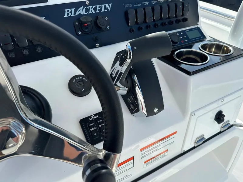 Slide: The Image of 2024 Blackfin 222CC boat dashboard with steering wheel and control panel. - 23