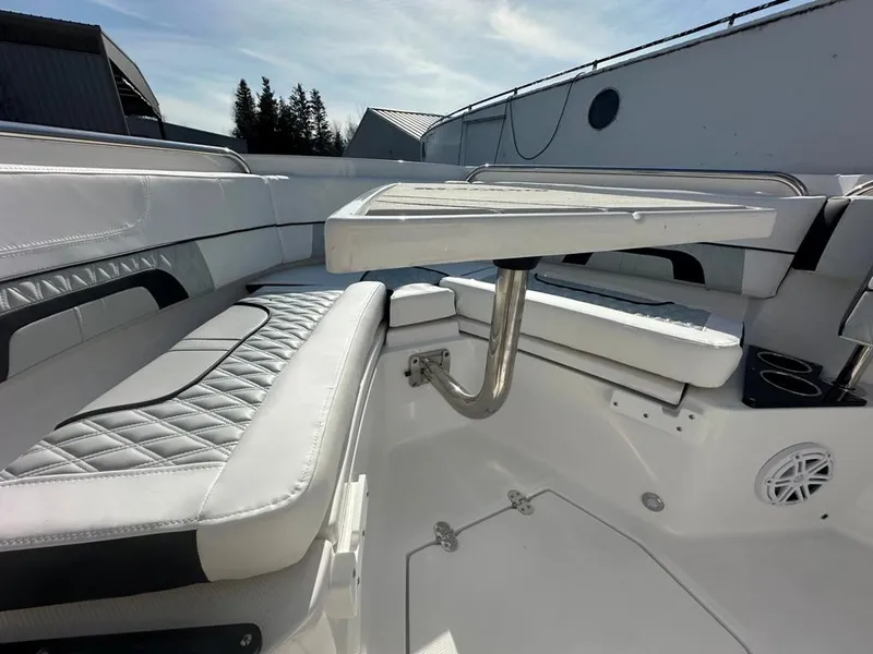 Slide: The Image of 2024 Blackfin 222CC boat interior with cushioned seating and table, showcasing luxury design. - 30