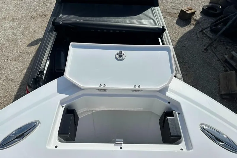 Slide: The Image of 2024 Blackfin 222CC boat storage compartment with open lid, showcasing interior space. - 34