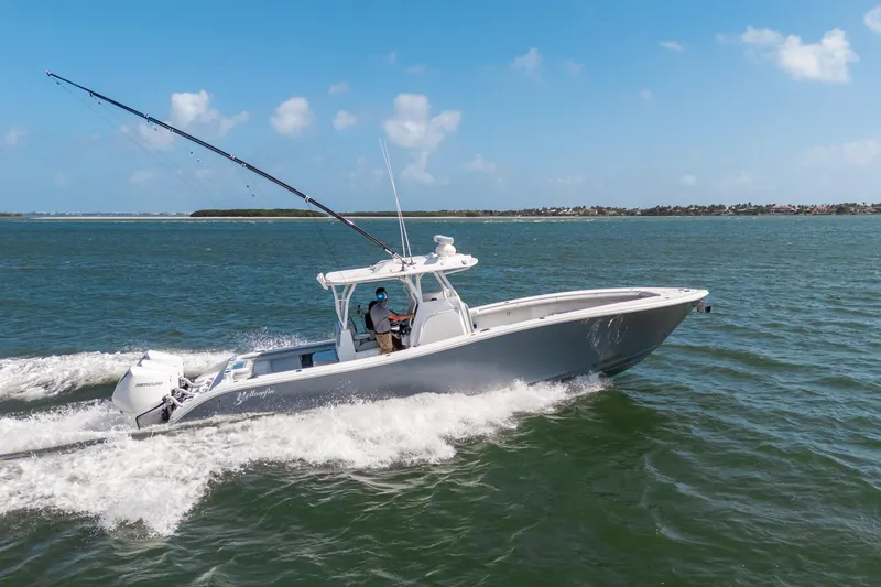 Slide: The Image of 2023 Yellowfin 36 Center Console boat cruising on open water under clear blue skies. - 0