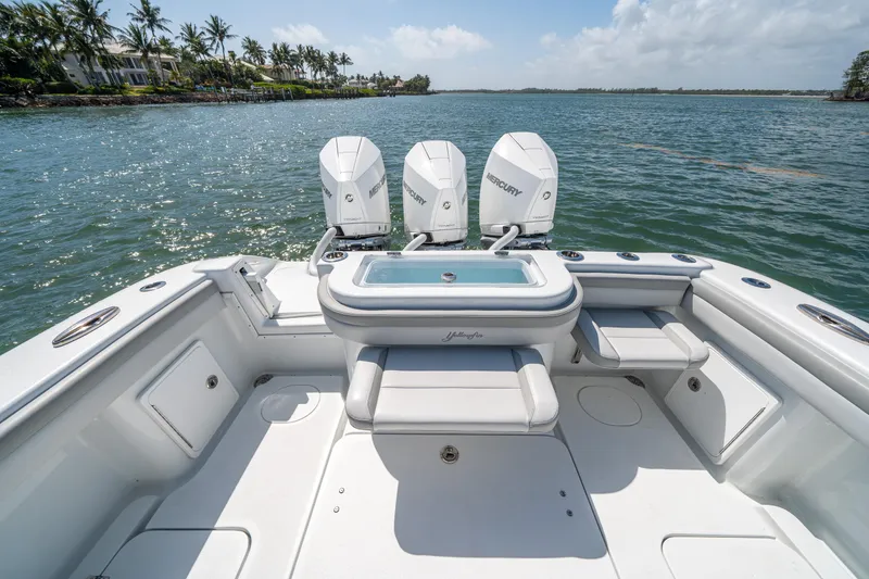 Slide: The Image of 2023 Yellowfin 36 Center Console boat with triple outboard engines on a sunny day. - 12