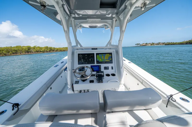 Slide: The Image of 2023 Yellowfin 36 Center Console boat interior with navigation system on calm water. - 13