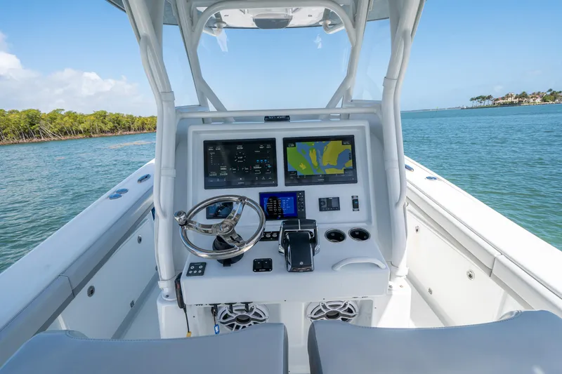 Slide: The Image of 2023 Yellowfin 36 Center Console boat dashboard with navigation screens on open water. - 14