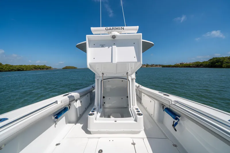 Slide: The Image of 2023 Yellowfin 36 Center Console boat on water, open storage compartment, clear sky. - 20
