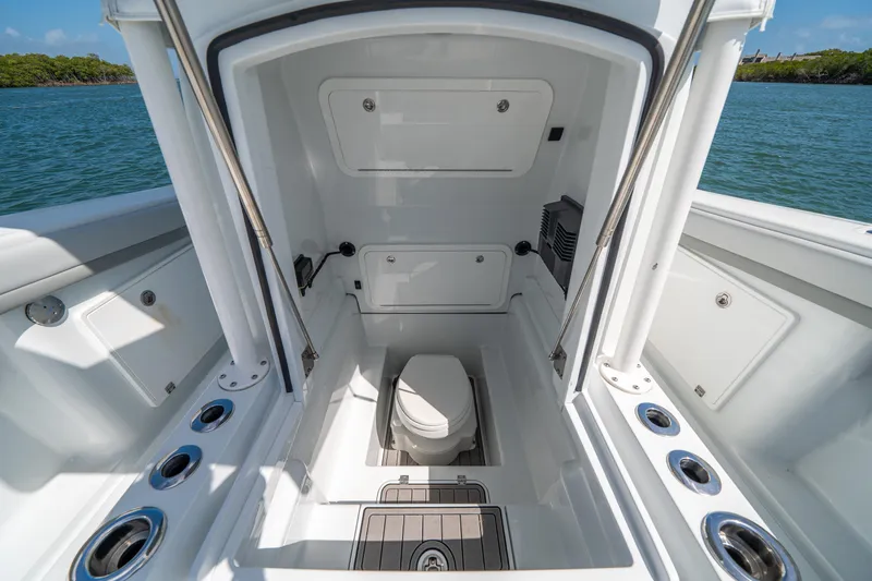 Slide: The Image of 2023 Yellowfin 36 Center Console boat interior with marine toilet, open hatch, and cup holders. - 21