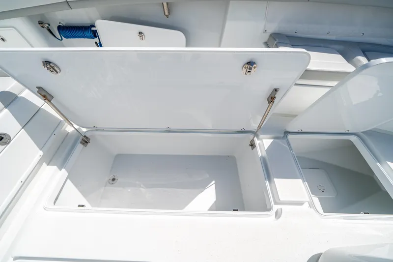 Slide: The Image of 2023 Yellowfin 36 Center Console storage compartments open on deck. - 22