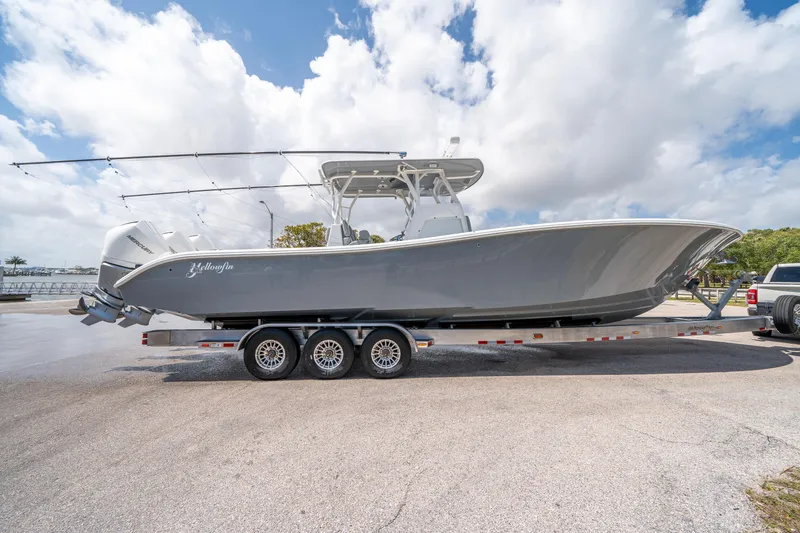Slide: The Image of 2023 Yellowfin 36 Center Console boat on trailer under cloudy sky. - 23