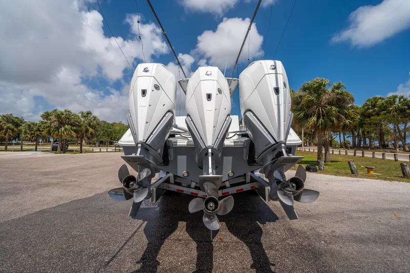 Slide: The Image of 2023 Yellowfin 36 Center Console with triple outboard engines, parked on a sunny day. - 24