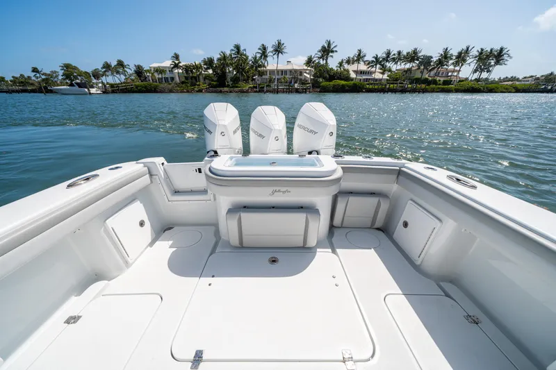 Slide: The Image of 2023 Yellowfin 36 Center Console boat with triple outboard engines on calm water. - 8