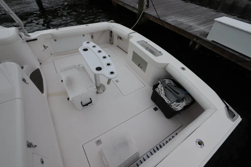 Slide: The Image of 2007 Cabo 40 Hardtop Express boat deck with fishing rod holders and storage compartments. - 10