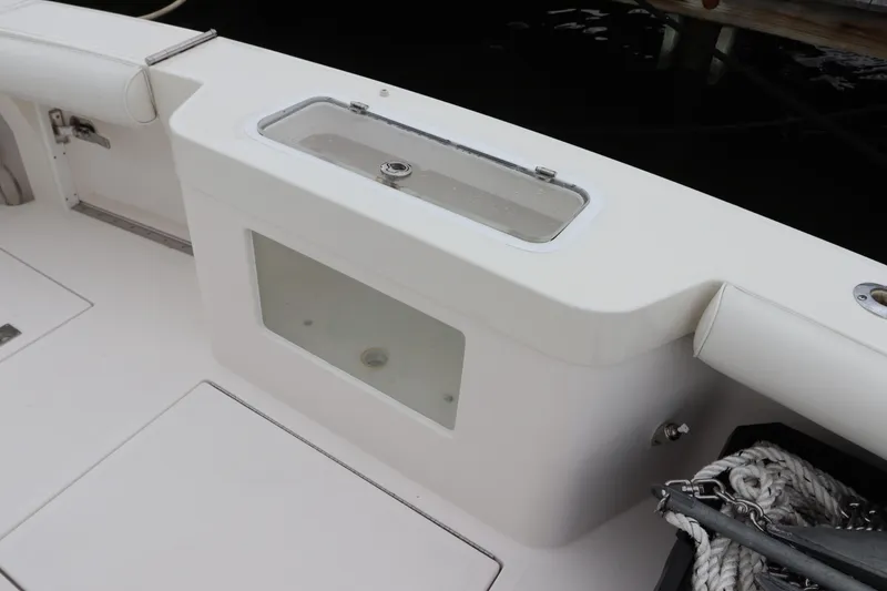 Slide: The Image of 2007 Cabo 40 Hardtop Express boat deck with storage compartment and ropes. - 11