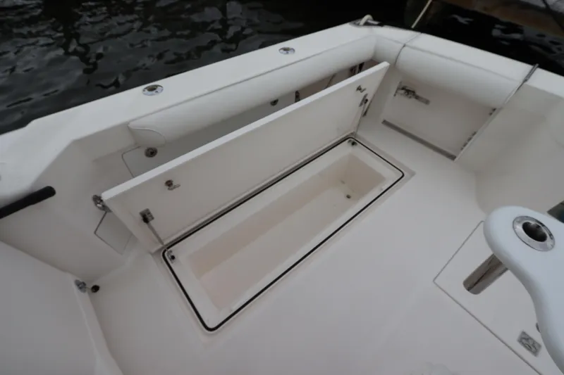 Slide: The Image of 2007 Cabo 40 Hardtop Express boat deck with open storage compartment. - 13