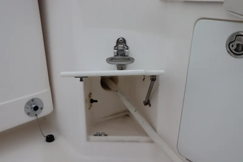 Slide: The Image of 2007 Cabo 40 Hardtop Express boat compartment with open hatch and visible pipe. - 14