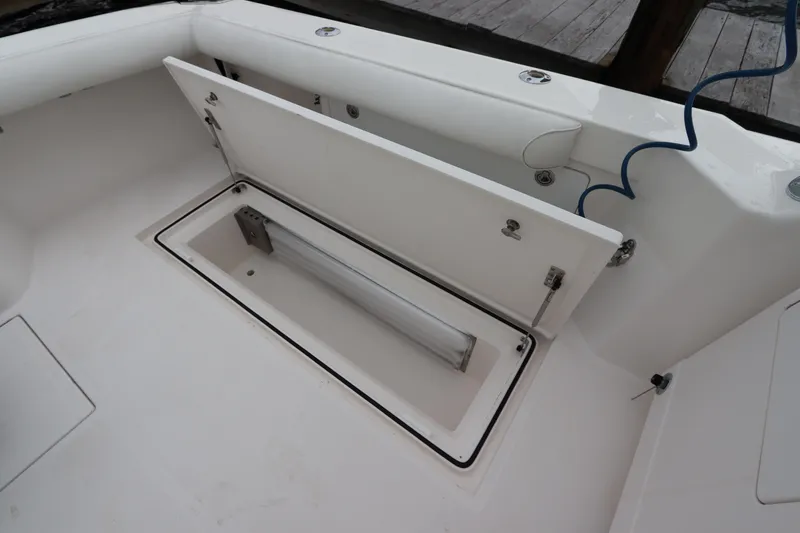 Slide: The Image of Open storage compartment on 2007 Cabo 40 Hardtop Express boat deck. - 15