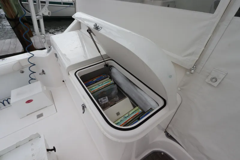 Slide: The Image of Open storage compartment on 2007 Cabo 40 Hardtop Express boat deck. - 19